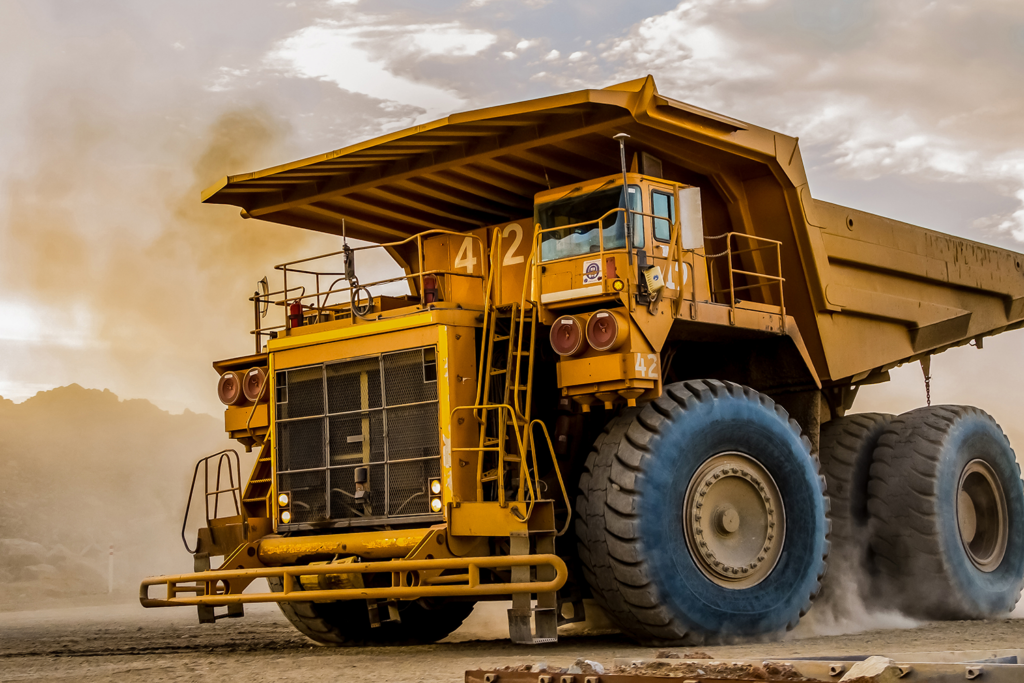 heavy yellow rigid hauler truck used for platinum mining