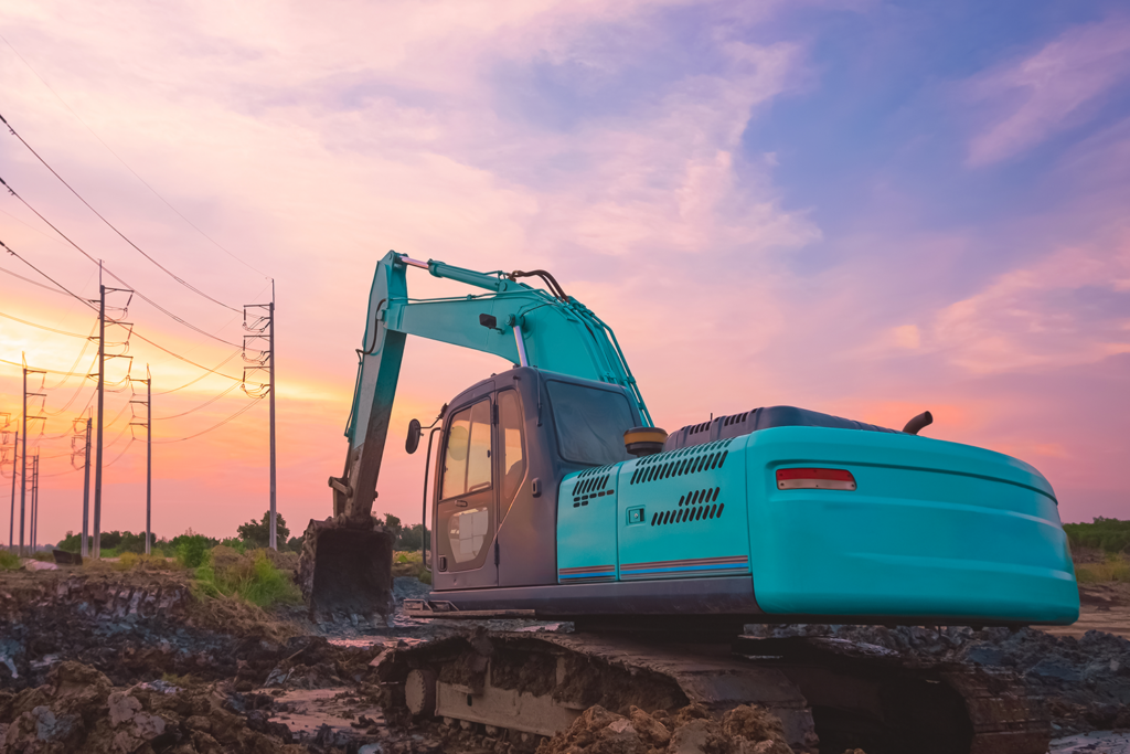 excavator is leveling the ground in field